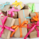 Pile of gifts with colorful ribbons against a white background.